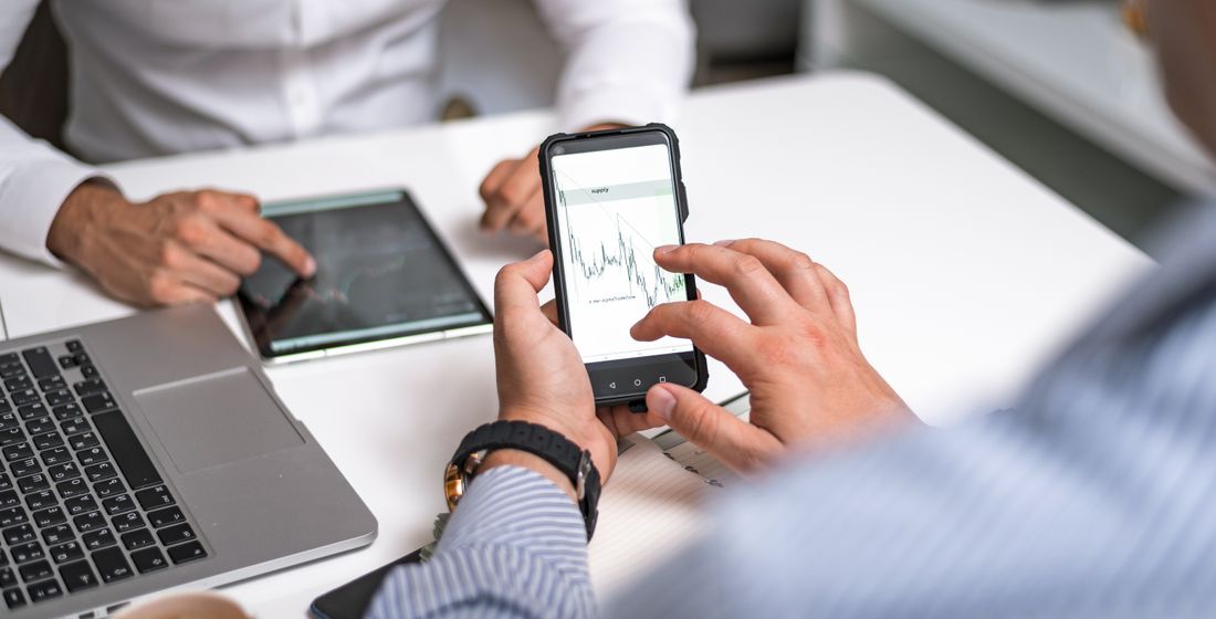 Marketers reviewing campaign performance on a phone and tablet